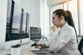 Asian female software developer is worried about analyzing code-based systems at his office Royalty Free Stock Photo
