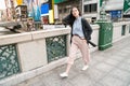 Asian female strolling in the street.