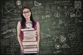 Asian female student bring stack of books in class Royalty Free Stock Photo