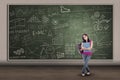 Asian female student standing at written board