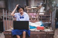 Asian female students in uniforms having trouble using laptop computers in rural area of Thailand.Education and technology use Royalty Free Stock Photo