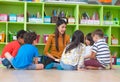 Asian female teacher teaching mixed race diversity group of kids Royalty Free Stock Photo