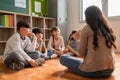 Asian Female Teacher telling story with her Pupils Royalty Free Stock Photo