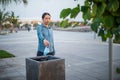 Woman throwing a used surgical face mask in the trash outdoors Royalty Free Stock Photo