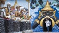 Asian female tourist in protective mask using smartphone while walking to look Buddhist art statues around