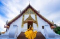 Asian female tourist wearing a yellow dress visits Phumin Temple in Nan province, Thailand