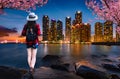 Asian female tourists stand to see the beautiful night lights in Busan, South Korea