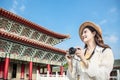 Asian female traveler photographing temples at Asia