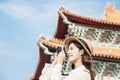 Asian female traveler photographing temples at Asia