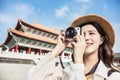 Asian female traveler photographing temples at Asia