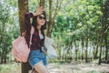 Asian female traveler tiring from lost her way in forest. Woman wiping sweat away  by hand. Solo girl traveling and Adventure Royalty Free Stock Photo