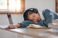 Asian female University student Sleeping on the table Because of tried from studying online at home during self Royalty Free Stock Photo