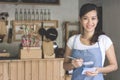 Asian female waiter in apron writing order Royalty Free Stock Photo