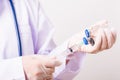 Woman doctor with stethoscope wearing face mask protective in the laboratory holding syringe and medicine vial vaccine Royalty Free Stock Photo