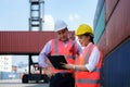 Asian female worker is explaining a check list of container inspections to the supervisor in container depot terminal Royalty Free Stock Photo