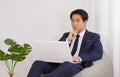 Asian Financial Advisor Thinking and Use Laptop in Home Office