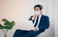 Asian Financial Advisor Wear Mask and Headphone Thinking in Vintage Tone