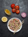 Asian Fish Salad on the black table. Top view. Royalty Free Stock Photo