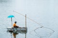 Asian fisherman fishing in the river morning