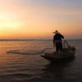 Asian fisherman with his wooden boat going to catching fish Royalty Free Stock Photo