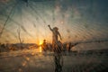 Asian fisherman on wooden boat casting a net for catching freshwater fish Royalty Free Stock Photo