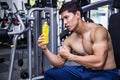 Asian fit man with energy drink relaxing and drinking in the gym. Sport and fittness concept.And Asian handsome muscles are tired Royalty Free Stock Photo