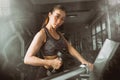 Asian fitness girl workout lifting a dumbbell in the gym. Royalty Free Stock Photo