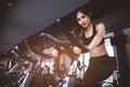 Asian fitness woman on bicycle doing spinning at gym. Beautiful Royalty Free Stock Photo