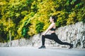 Asian fitness woman runner stretching legs before run Royalty Free Stock Photo