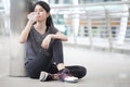 asian fitness woman taking a break after workout exercising drinking with a water bottle on street in urban city . Tired sport Royalty Free Stock Photo