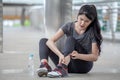 asian fitness young woman Running injury leg accident of workout exercising on street in urban city . sport runner girl sitting Royalty Free Stock Photo