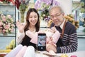 Asian florists family demonstrate flower arrangements via online live streaming.