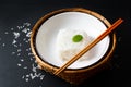 Asian Food concept cooked Thail jasmine rice long grain rice in ceramic bowl and bamboo tray on black slate board background with