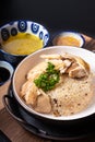 Asian Food concept Hainanese Chicken Rice with sour and sweet soy sauce on wooden board with slate stone background