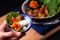 Asian food concept homemade Korean Grilled pork belly BBQ Samgyeopsal-gui with kimchi and shiso and salad on black background with Royalty Free Stock Photo