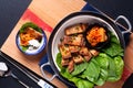 Asian food concept homemade Korean Grilled pork belly BBQ Samgyeopsal-gui with kimchi and shiso and salad on black background with Royalty Free Stock Photo