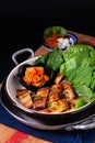 Asian food concept homemade Korean Grilled pork belly BBQ Samgyeopsal-gui with kimchi and shiso and salad on black background with Royalty Free Stock Photo