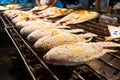 Asian food. Counter with fish in salt on the grill at a night food street market Royalty Free Stock Photo