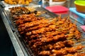 Asian food. A counter with mini kebabs of chicken skin and meat at a nightly street food market Royalty Free Stock Photo