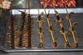 Asian food. Fried centipedes and scorpions on skewers Royalty Free Stock Photo
