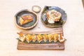 Asian food menu with an uramaki california roll with masago roe