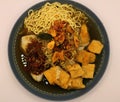 asian food, Noodles in a blue bowl with tofu on white Royalty Free Stock Photo