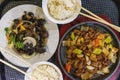 Asian food, roast meat and rice with chopsticks in the bowl, vegetables and mushroom, top view. Gastronomic gourmet Royalty Free Stock Photo