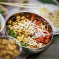 Asian food, spicy soup with vegetables, seafood and germinated soybean sprouts in a bowl close-up, top view. Selective