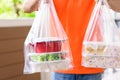 Delivery man delivering Asian food in take away boxes to customer at home Royalty Free Stock Photo