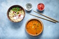 Asian food, Tom Yam and Ramen with shrimps, Thai food in wooden bowl, Egg noodles, Spicy, Top view on light gray background, Selec Royalty Free Stock Photo