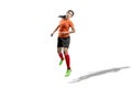 Asian football player woman jumps in the air and trying to heading the ball Royalty Free Stock Photo