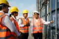 Asian foreman is explaining and teaching new training workers for various components of container to new inspection container