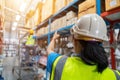 Asian Foreman and female laborer working in a warehouse. Working Woman Concept