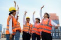 Asian foreman and his team staff in the container depot terminal arm raise celebration delighted to accomplish their goals success Royalty Free Stock Photo